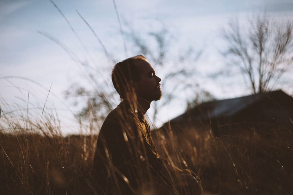 Title image: Man trying to find inner peace by being in nature